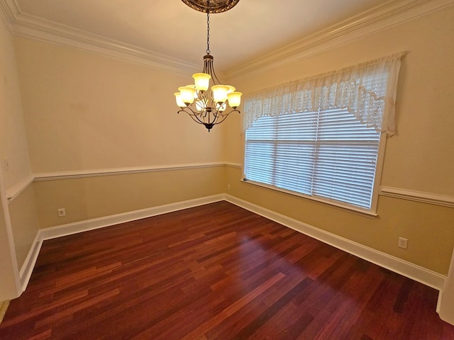 empty room featuring crown molding, dark wood-type flooring, and a chandelier