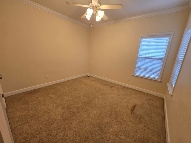 empty room featuring crown molding, ceiling fan, and carpet flooring