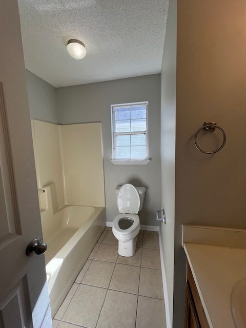 full bathroom featuring tub / shower combination, vanity, a textured ceiling, tile patterned floors, and toilet