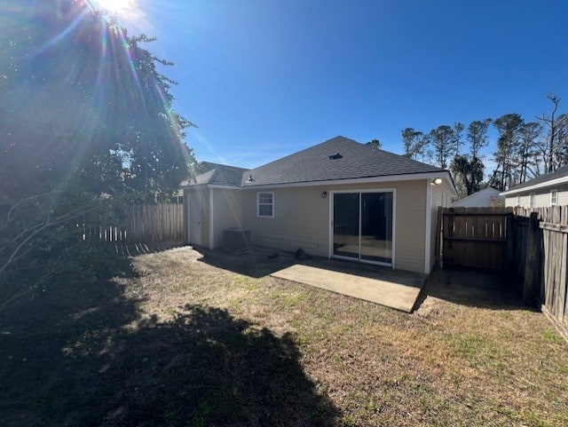 back of house with a yard and a patio