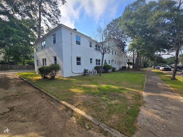 view of home's exterior with a lawn