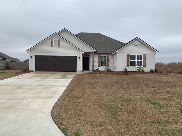 view of front of home with a garage and a front lawn