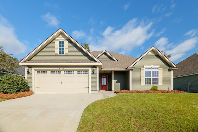 view of front of house with a garage and a front lawn