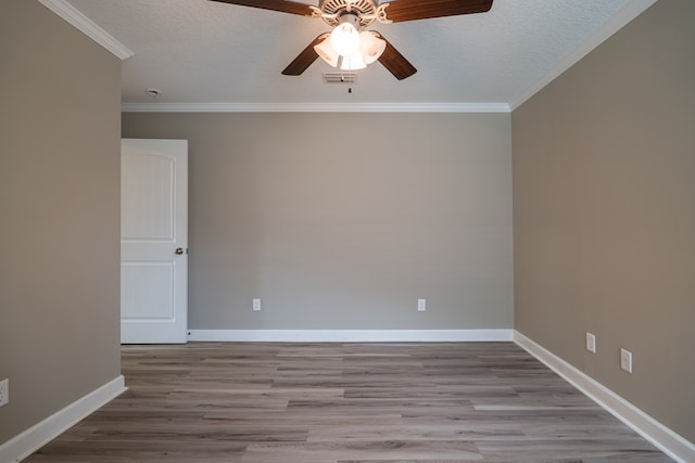 empty room featuring a textured ceiling, light hardwood / wood-style flooring, ceiling fan, and crown molding