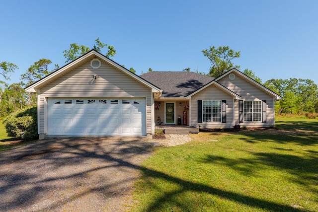 ranch-style home featuring a front yard, an attached garage, and aphalt driveway