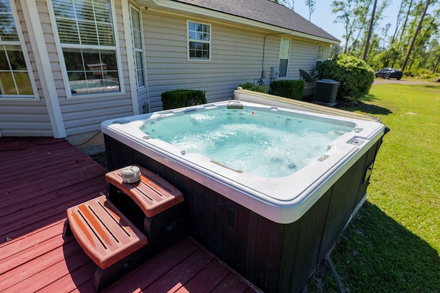 deck with a yard, central AC, and a hot tub