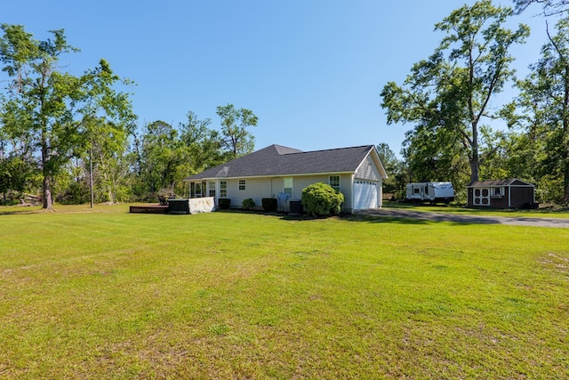 view of home's exterior featuring central AC, an attached garage, a lawn, and driveway