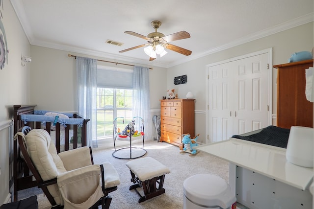 interior space featuring crown molding, visible vents, a ceiling fan, and a closet