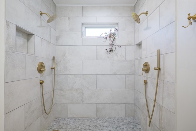 full bathroom with tiled shower and ornamental molding
