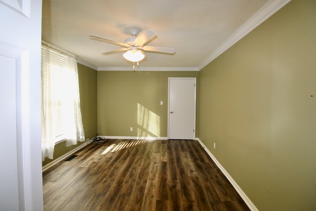 empty room featuring ornamental molding, dark wood-type flooring, and ceiling fan