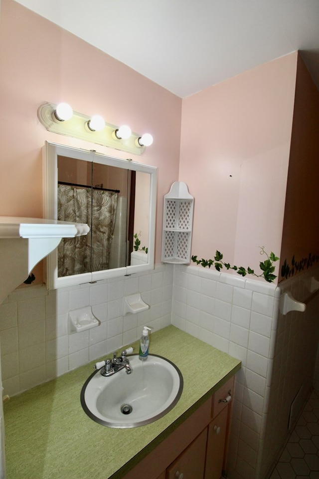 bathroom with tasteful backsplash, vanity, and tile patterned flooring