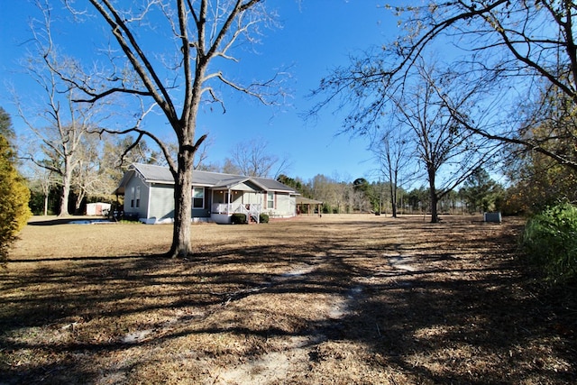 view of yard with covered porch