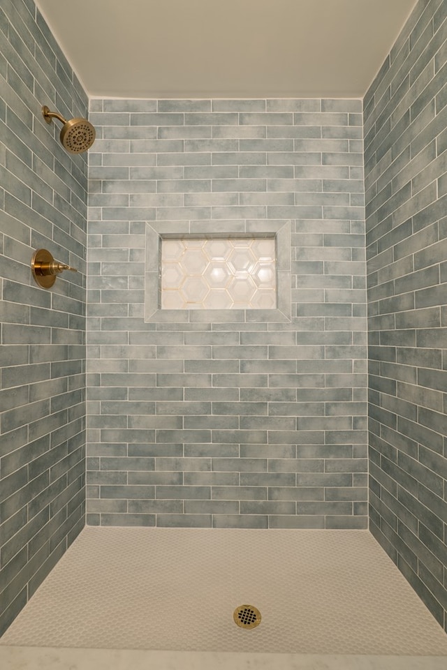 full bathroom with tiled shower