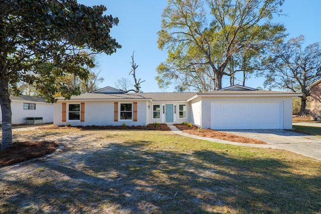 single story home featuring a front lawn, brick siding, a garage, and driveway