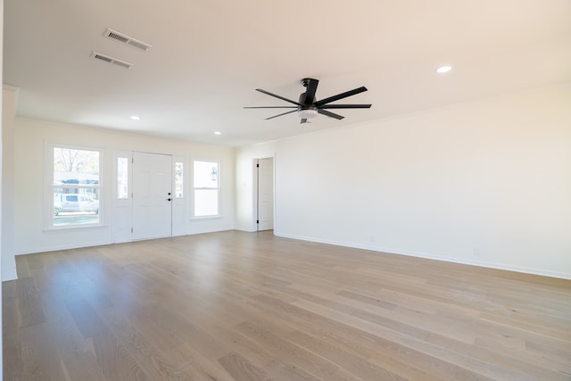 unfurnished living room with visible vents, baseboards, and light wood-style flooring