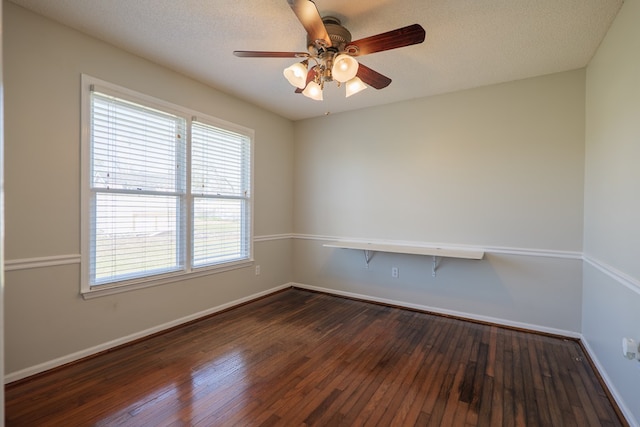 spare room featuring ceiling fan, a textured ceiling, baseboards, and dark wood-style flooring