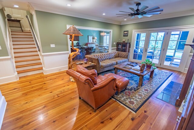 4059 Live Oaks Cir, Valdosta, GA 31601 - living room featuring stairs, wainscoting, hardwood / wood-style floors, ornamental molding, and a ceiling fan