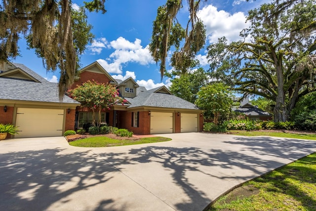 4059 Live Oaks Cir, Valdosta, GA 31601 - view of front of house featuring driveway, brick siding, an attached garage, and roof with shingles