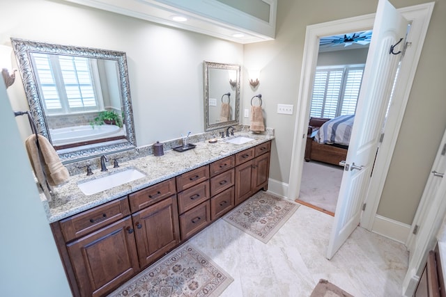 4059 Live Oaks Cir, Valdosta, GA 31601 - bathroom featuring double vanity, a bath, and ensuite bathroom