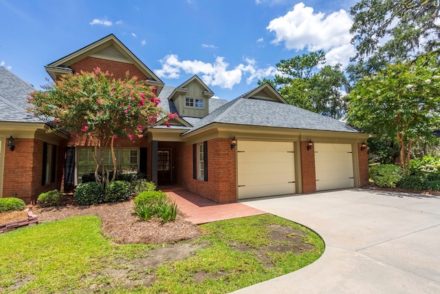 4059 Live Oaks Cir, Valdosta, GA 31601 - view of front of house with brick siding, concrete driveway, a garage, and roof with shingles