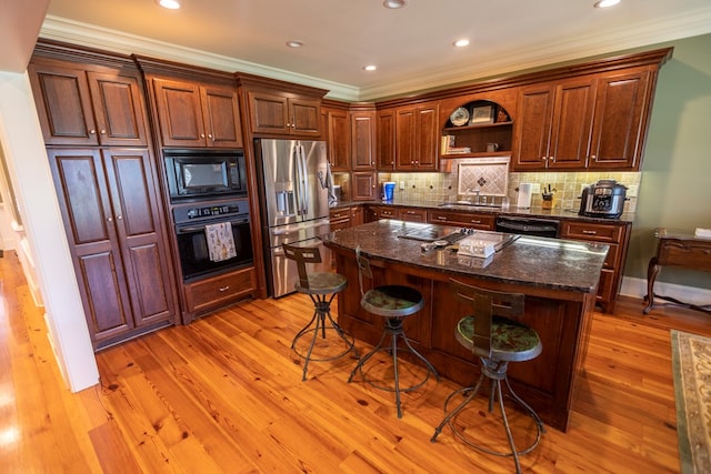 4059 Live Oaks Cir, Valdosta, GA 31601 - kitchen with black appliances, open shelves, light wood finished floors, a kitchen bar, and crown molding