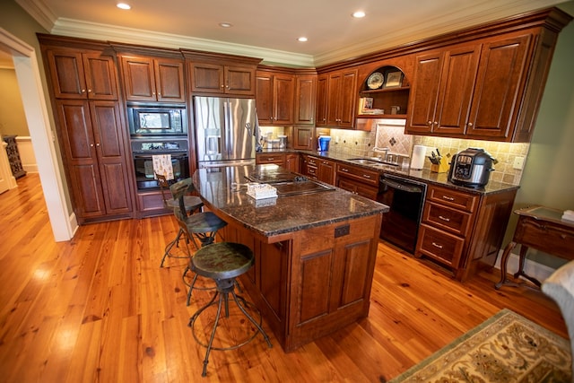 4059 Live Oaks Cir, Valdosta, GA 31601 - kitchen with black appliances, ornamental molding, a kitchen breakfast bar, light wood finished floors, and open shelves