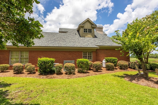 4059 Live Oaks Cir, Valdosta, GA 31601 - view of property exterior with brick siding, a yard, and a shingled roof