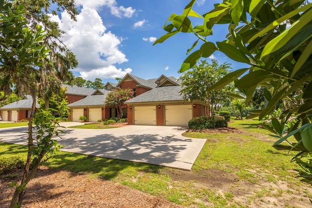 4059 Live Oaks Cir, Valdosta, GA 31601 - view of front of house with a garage, brick siding, driveway, and roof with shingles
