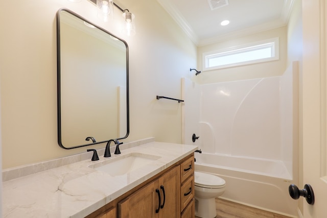 bathroom with visible vents, toilet, vanity, ornamental molding, and shower / bathtub combination