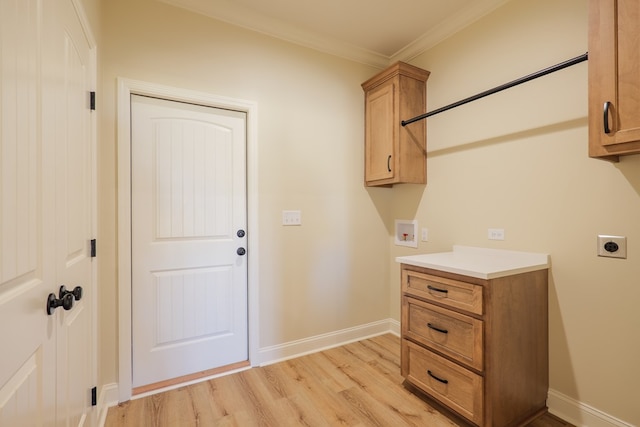 laundry area featuring cabinet space, baseboards, light wood-style flooring, washer hookup, and electric dryer hookup