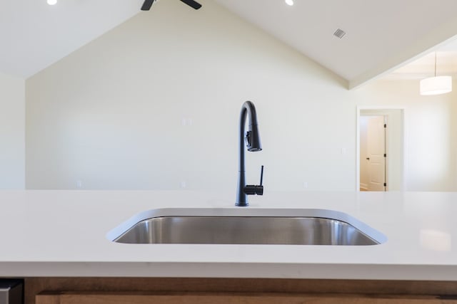 details featuring a sink, visible vents, a ceiling fan, light countertops, and pendant lighting