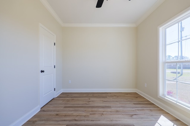 spare room with light wood-type flooring, crown molding, baseboards, and ceiling fan