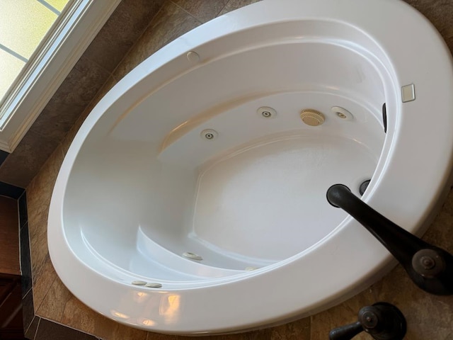 room details featuring a sink and a tub with jets