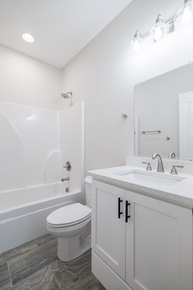 full bathroom with toilet, vanity, wood-type flooring, and tub / shower combination