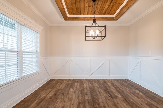 unfurnished dining area featuring dark hardwood / wood-style floors, crown molding, a tray ceiling, and a notable chandelier