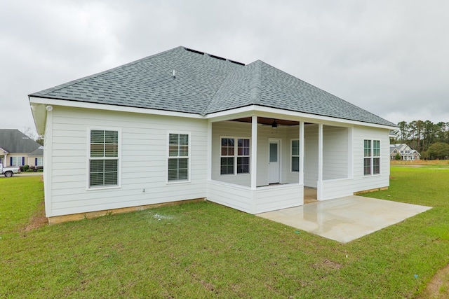 back of house with ceiling fan, a yard, and a patio