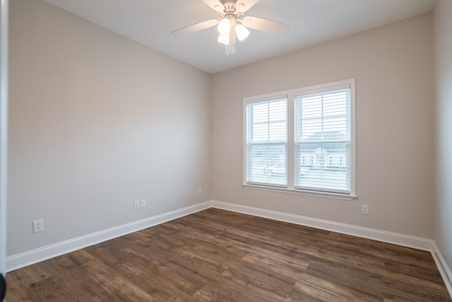 spare room with dark hardwood / wood-style floors and ceiling fan