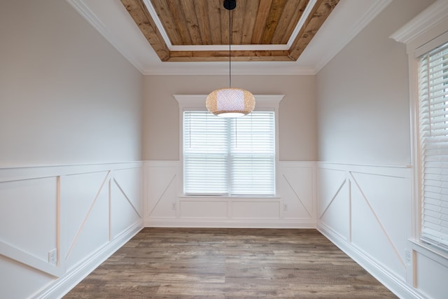 unfurnished dining area featuring wood-type flooring, a tray ceiling, ornamental molding, and wood ceiling