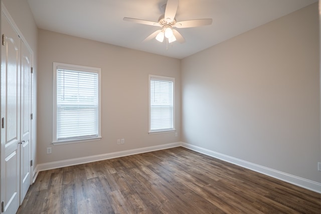 empty room featuring ceiling fan and dark wood-type flooring