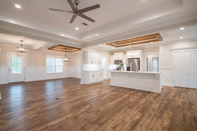 unfurnished living room with dark wood-type flooring, a raised ceiling, ceiling fan, and crown molding