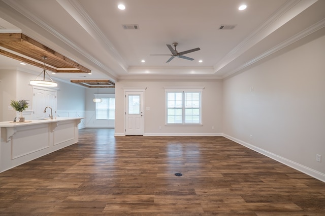 unfurnished living room with dark hardwood / wood-style floors, crown molding, and a tray ceiling