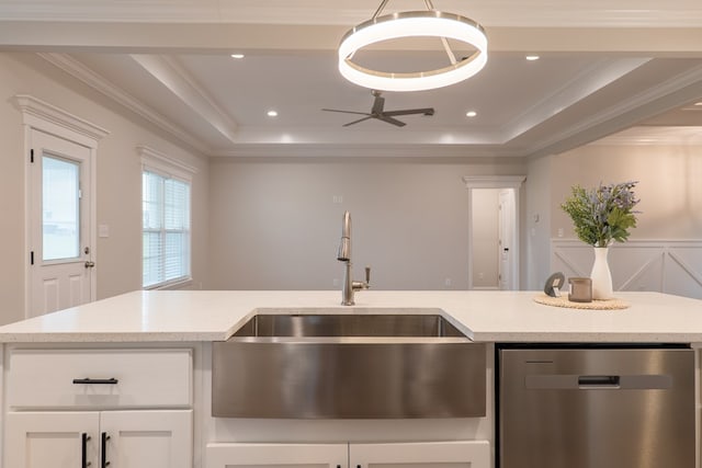 kitchen with light stone counters, stainless steel dishwasher, ornamental molding, sink, and white cabinets