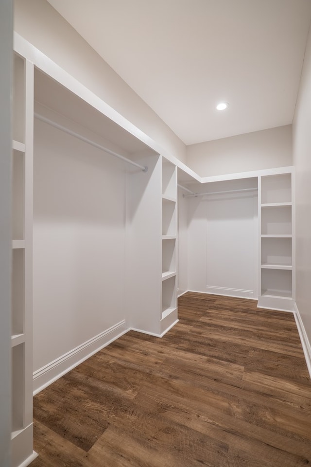 walk in closet with dark wood-type flooring