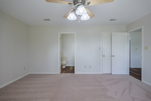 unfurnished bedroom featuring baseboards, visible vents, and carpet