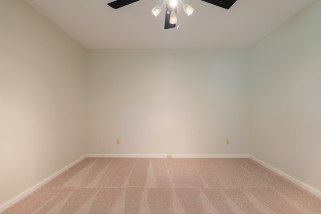 empty room featuring baseboards, ceiling fan, and light colored carpet