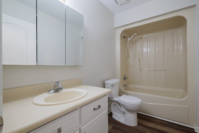 full bath featuring toilet, wood finished floors, vanity, and  shower combination