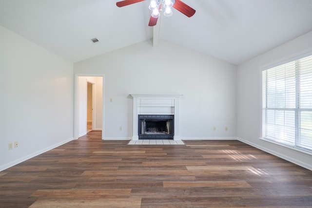 unfurnished living room with a fireplace with flush hearth, lofted ceiling with beams, a ceiling fan, visible vents, and wood finished floors
