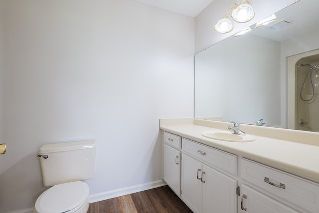 full bathroom with vanity, toilet, baseboards, walk in shower, and wood finished floors