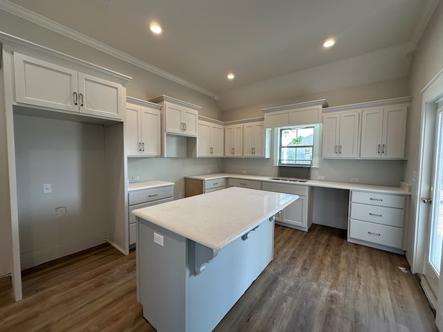 kitchen featuring dark hardwood / wood-style floors, white cabinets, a center island, and ornamental molding