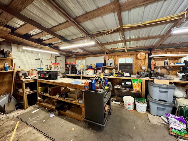 miscellaneous room with concrete flooring and a workshop area